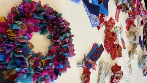 A sari fabric wreath and materials at a wreath making workshop